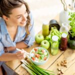 Woman happily eating a healthy meal.