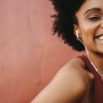 Woman smiling at camera wearing headphones