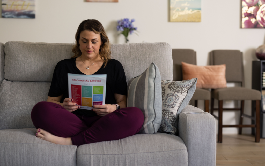 Woman on Couch Reading Handout