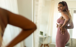 A Woman Looking Happy in Mirror Because She Used FSA for Weight Loss