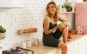 A Woman Sitting On the Kitchen Counter as She Does a Seasonal Detox